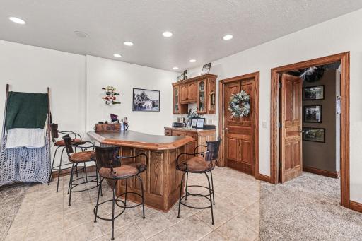 Includes a beautiful oak wet bar area with tile flooring