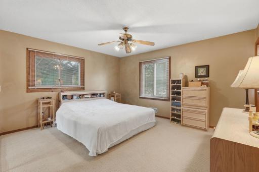 Primary bedroom with new carpet andceiling fan