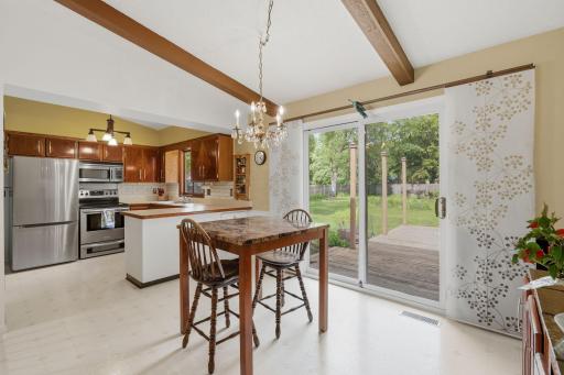 Bright dinning area with open kitchen. Large sliding door going to a massive deck