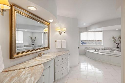 You must see this huge primary bath, complete with stackable washer/dryer