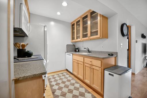 new bosch dishwasher, glass cabinets doors and solid corian countertops