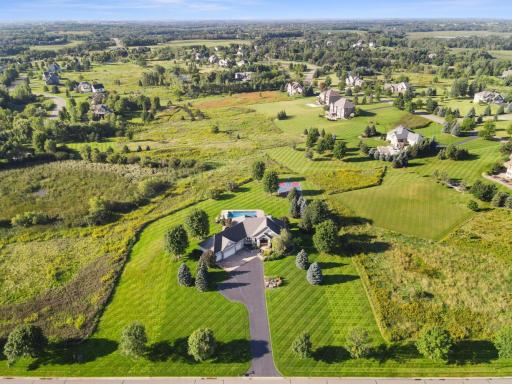 View of the layout of the property, featuring the house, pool and sport court.