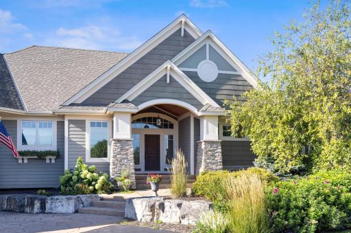Front door that is surrounded by the beautiful landscaping.