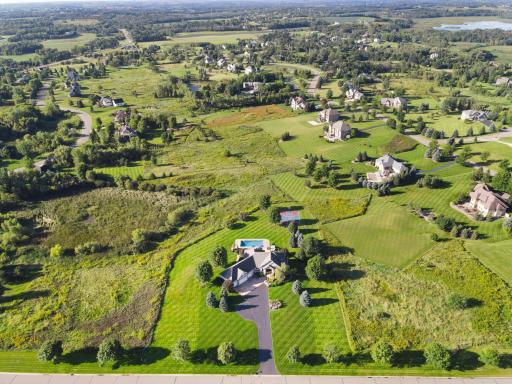 Drone view of the beautiful lot that this unreal home sits on.