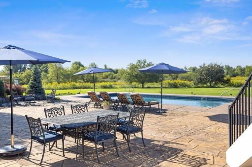 Catch some rays in lawn chairs with your view of the pool, the glorious yard and sport court which you will see soon in other angled photos. Various seating options and potential for whatever your needs are.