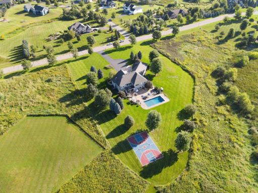 View of the back of the house with the sport court. Sport court can be used for tons of activities, basketball, pickleball, etc.
