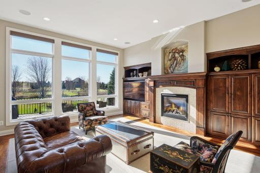 Glorious built ins on the main level. Various seating arrangement possibilities. Beautiful fireplace and views out to the backyard.