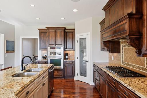 There is even storage and organization in the center island! Lovely gas stove top with unique backsplash.