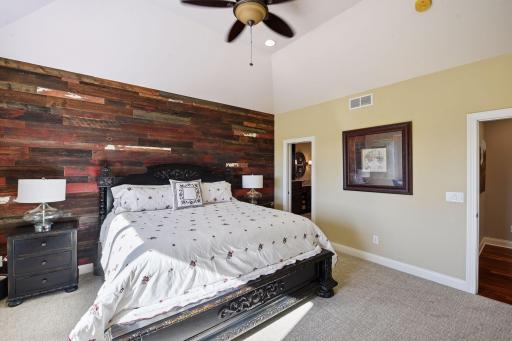 Primary bedroom with paneling on the walls, creates a unique and beautiful feel and plenty of options to decorate or incorporate accent colors.