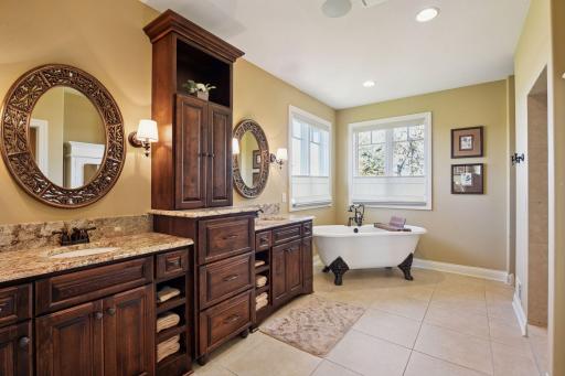 Primary bathroom with double vanity and a lot of cabinet storage. Perfect for organizing all your bathroom necessities and towels.