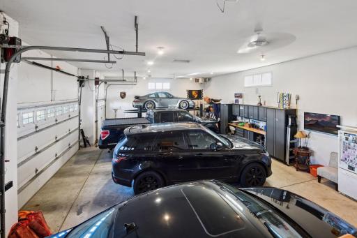 4 car garage with a lift that STAYS with the home! Such a bonus!