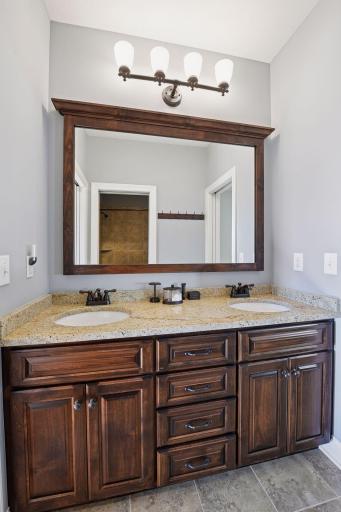 Jack and Jill bathroom between the 2nd and 3rd bedroom on the main floor. Double sink and cabinets galore.