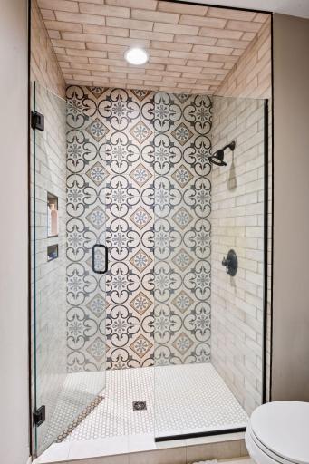 Lovely walk-in shower with immaculate tile. Check out the design with the wall built ins for your shower needs.