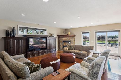Another great seating area in the basement with wall built ins and fire place. Come in after a hoop session or swim at the pool to warm up at the fire place and watch some TV.