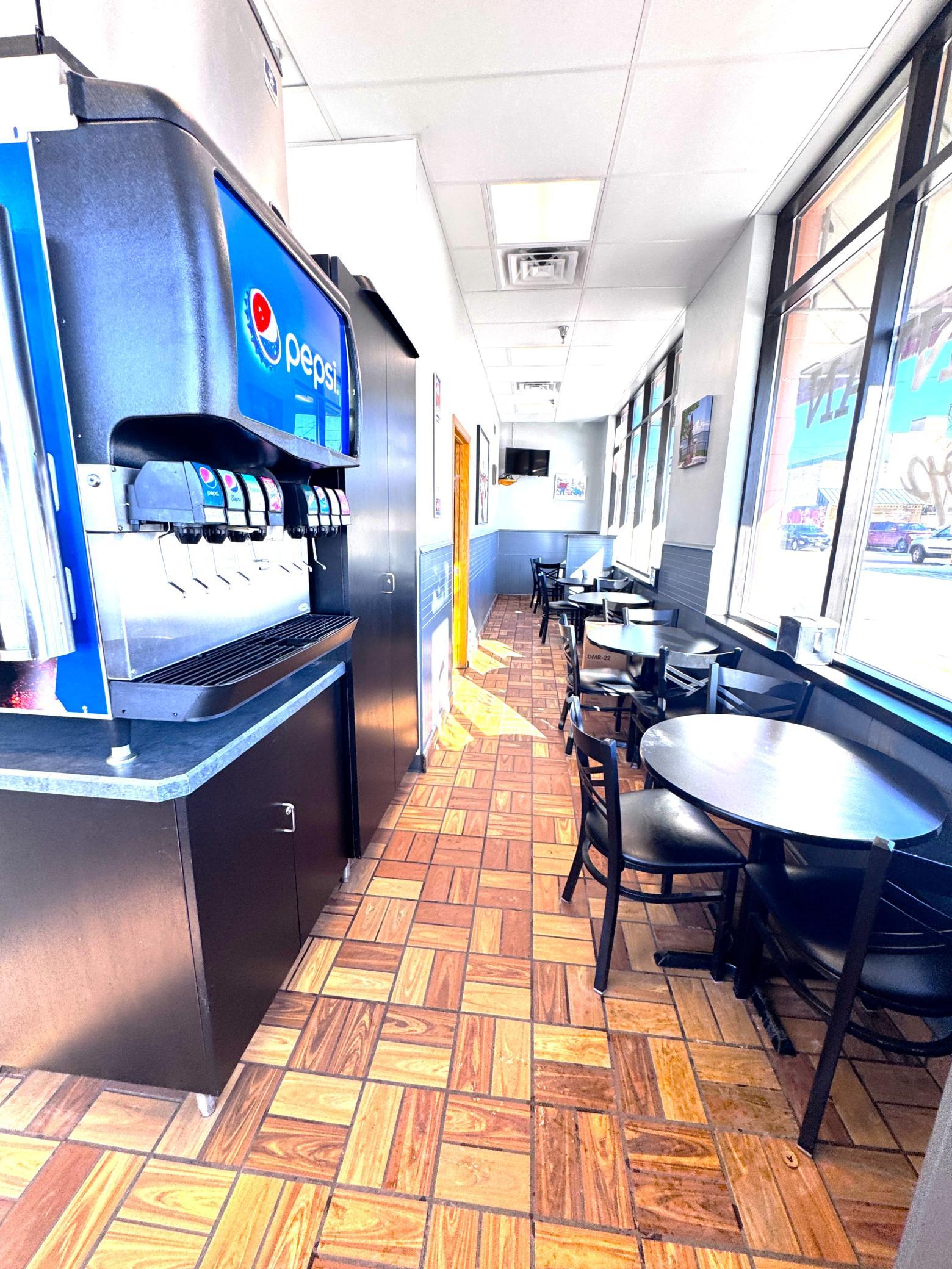 Pepsi fountain dispenser and side seating area.