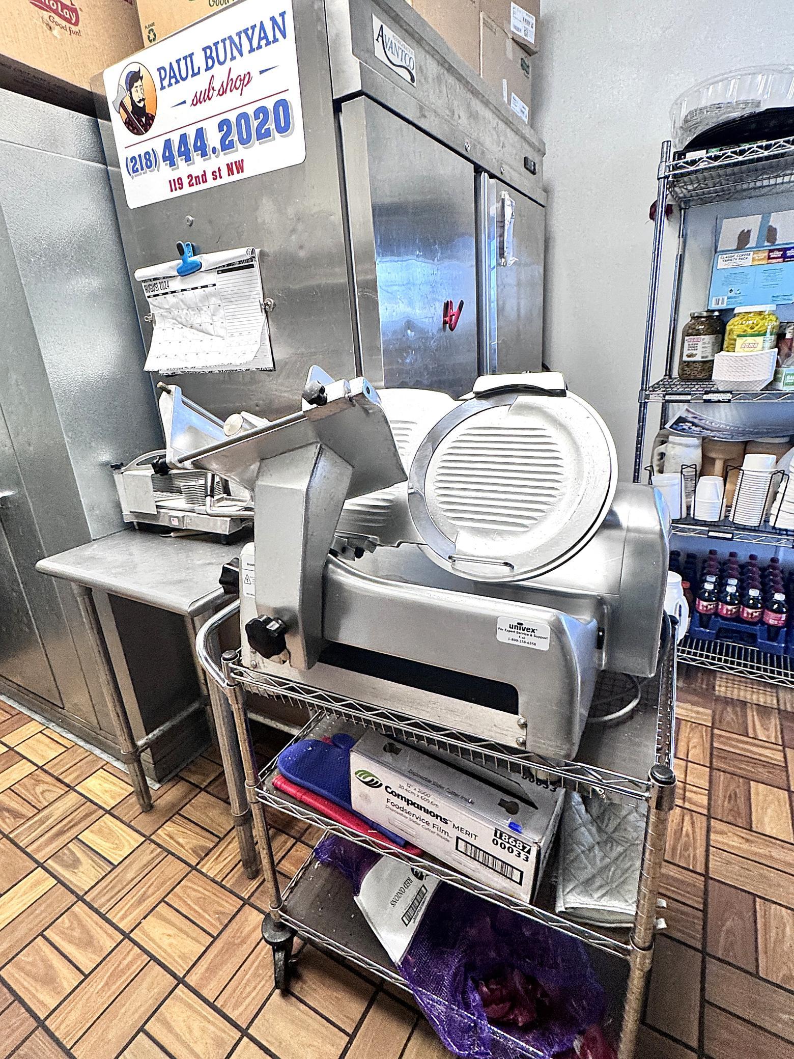 Meat slicer for cutting fresh deli meat for the sandwiches.
