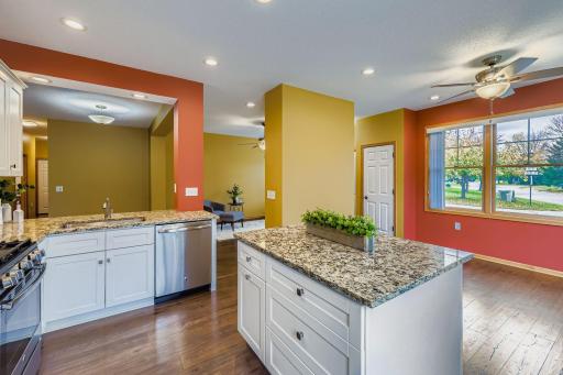 The spacious kitchen includes a gas range, laminate flooring and lots of windows for sunlit days.