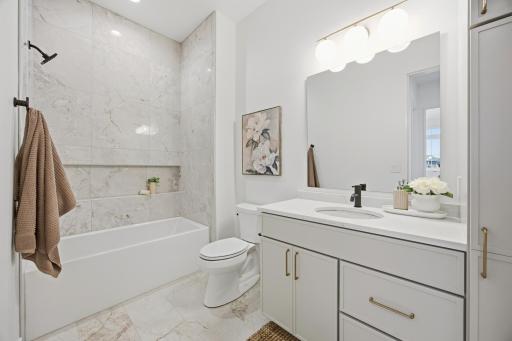 Main Floor Guest Bathroom with Tile Surround Tub/Shower