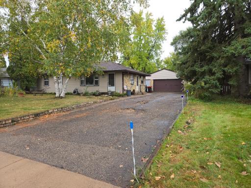 Front of home and quiet location with newer roof siding and stone siding driveway may need replacement or repairs