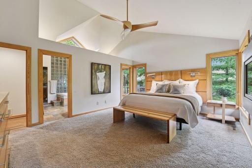 Vaulted open ceilings give visual space in the primary suite