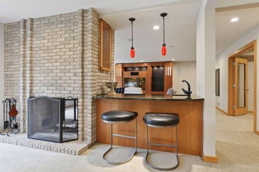 Dual-sided wood burning fireplace and bar