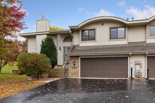 Beautifully landscaped 2 bed, 2 bath end unit townhome w/2car tuck-under garage across from play field in great Eagan location!