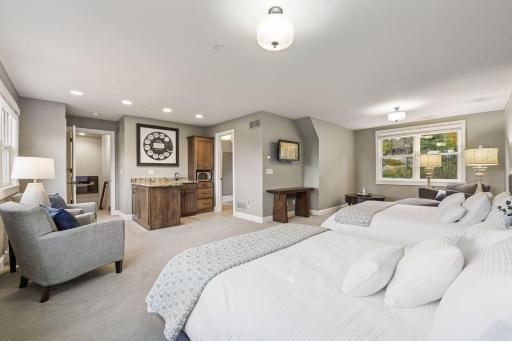 The versatile bonus room above the garage features a guest retreat with mini bar and private bathroom, perfect for a nanny or mother-in-law suite.