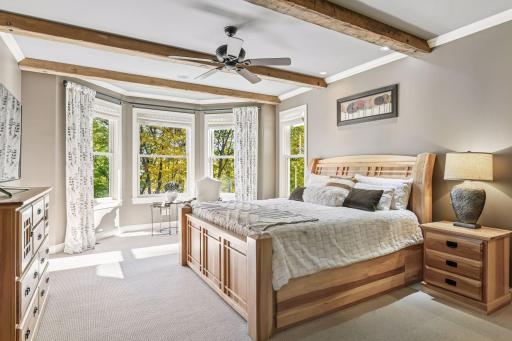 The main floor primary suite indulges with a spa-like bathroom, dual closets, and conveniently private owner's laundry.
