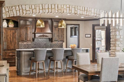 The eat-in kitchen was recently renovated offering custom cabinets, center island, quartz countertops, and professional grade appliances.