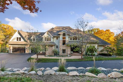 Architectural details include striking limestone accents inside and out, complemented by artisanal shakes and a textured concrete walkway.