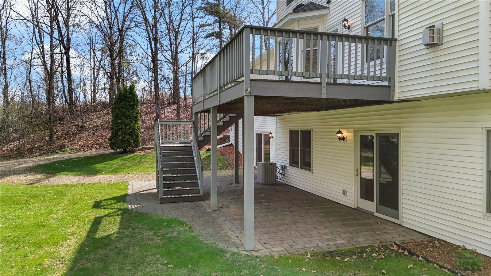 Paver patio under deck which has Trex decking