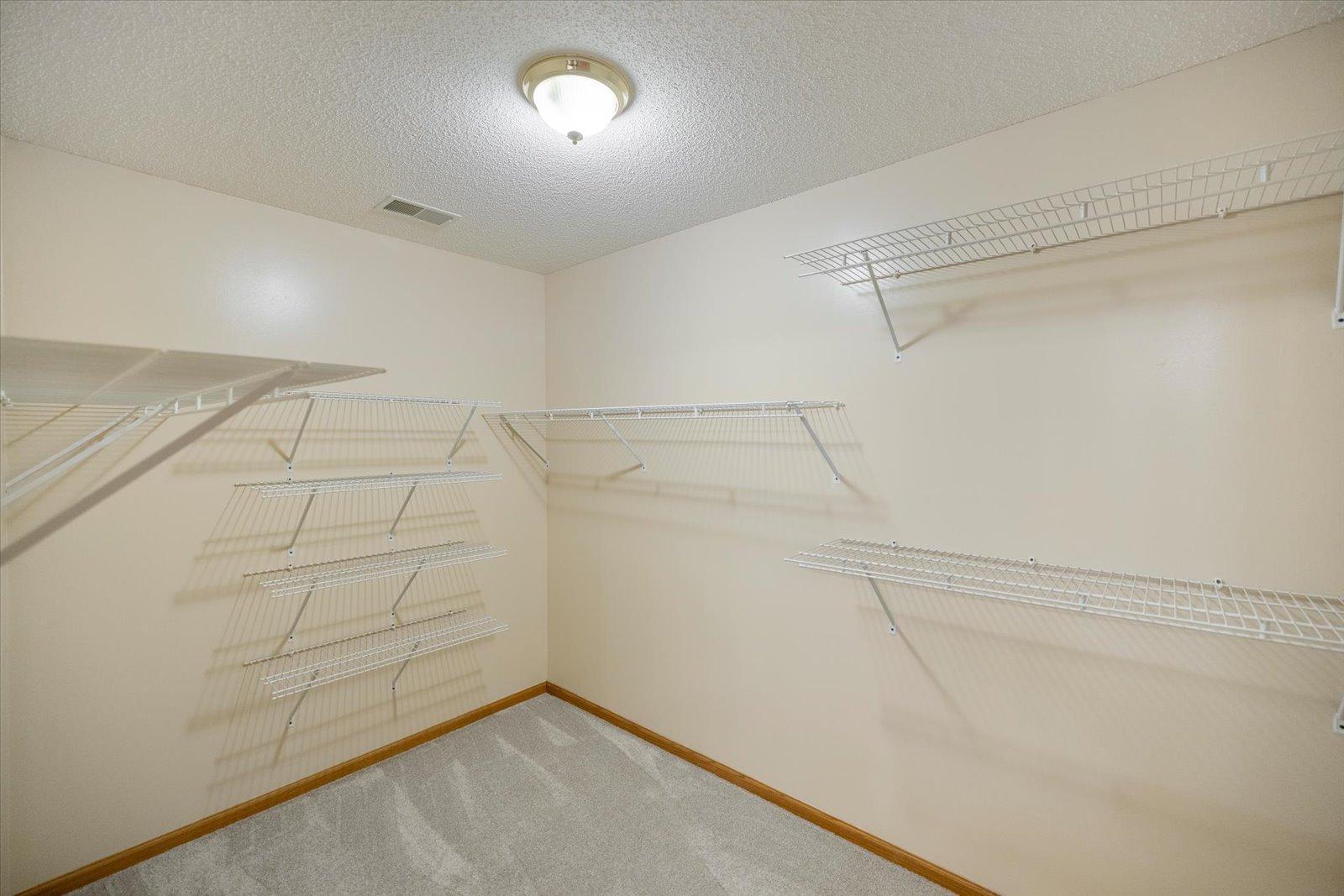 Walk in closet in primary bedroom