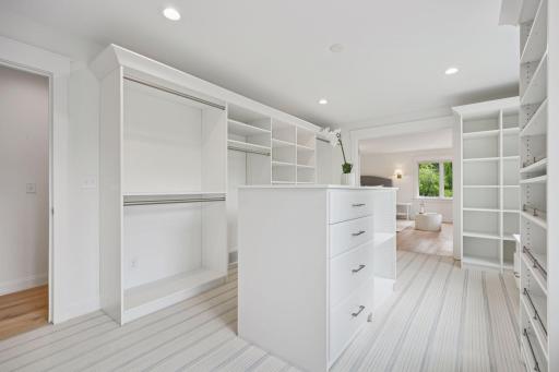 Walk through closet from hallway through to Primary bedroom
