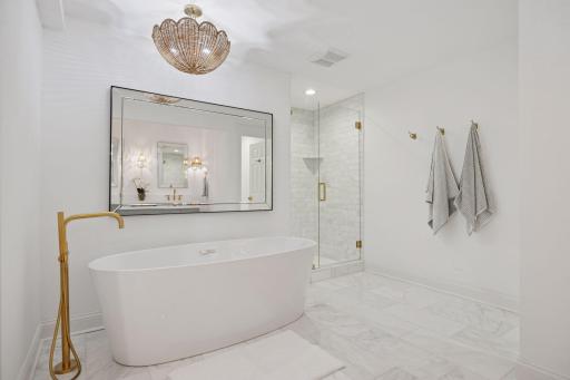 Primary Bathroom just completed a new renovation project with Carrera Marble floors and countertops, free standing bathtub.