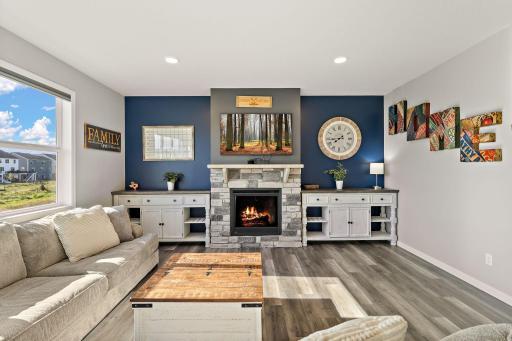 Living room is bright and cheerful! Beautiful gas fireplace has a stone front and stone mantel, ready at a moment's notice! Freshly painted, large picture window and luxury vinyl plank flooring