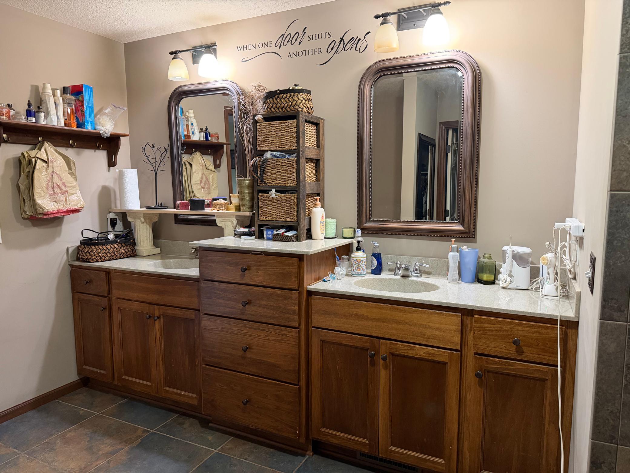 Part of the private owner's bath has dual sinks, slate tile, a jetted tub and a walk in shower and another large walk in closet.
