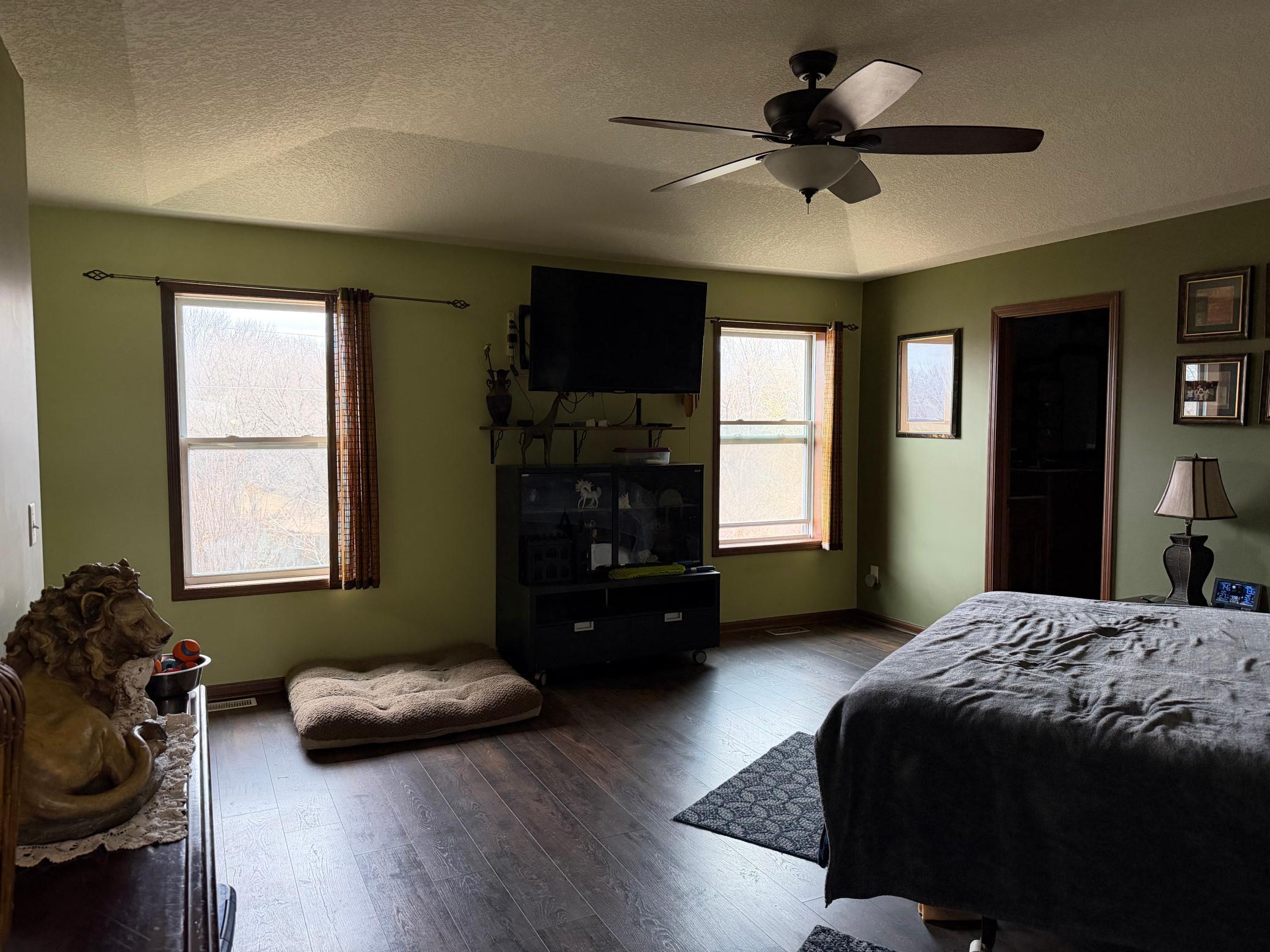 Very large owners suite with tray vault also has a large nook (not pictured) and leads to the private bath with dual sinks, jetted tub, huge walk in tile shower and walk in closet.