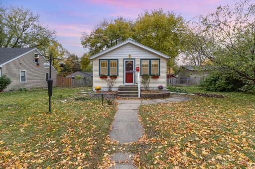 Charming front of home; garden, bird feeders, book library.