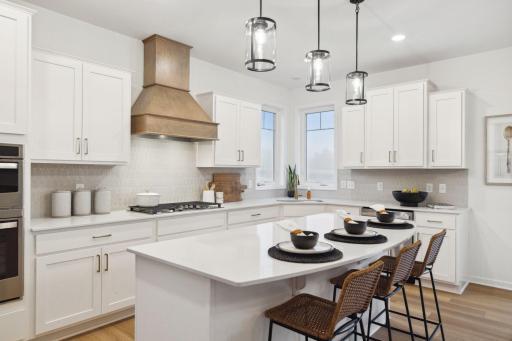 Photo for 14670 107th Place N, Maple Grove, MN 55369 - listing #6806342 Spacious kitchen with quartz island, bright functional design perfect for cooking and gathering. (Picture of Model home, colors and material may vary.)