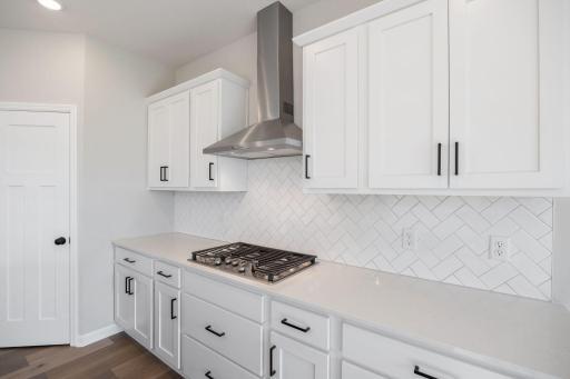 Gourmet kitchen with built-in applianaces. (Photo of the actual home.)