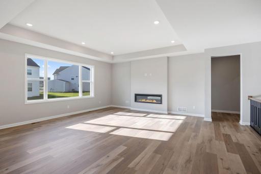 Family room with box vault ceiling and expansive picture windows. (Photo of a actual home.)