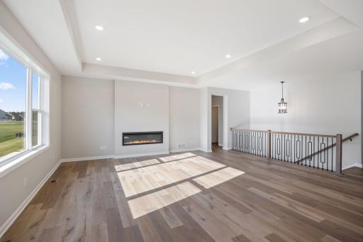 Family Room accented by decorative wrought iron railing. (Photo of actual home.)