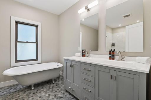 The full bathroom offers a comfort height vanity with double sinks and a classic clawfoot bathtub.