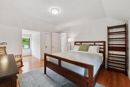 The upper level houses three bedrooms. This bedroom offers two closets and lake views.