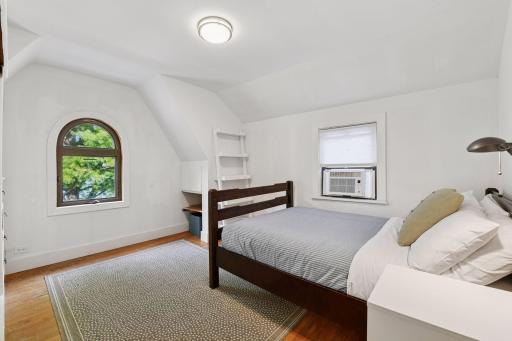 The third bedroom offers a wall of built-in drawers and cabinetry.