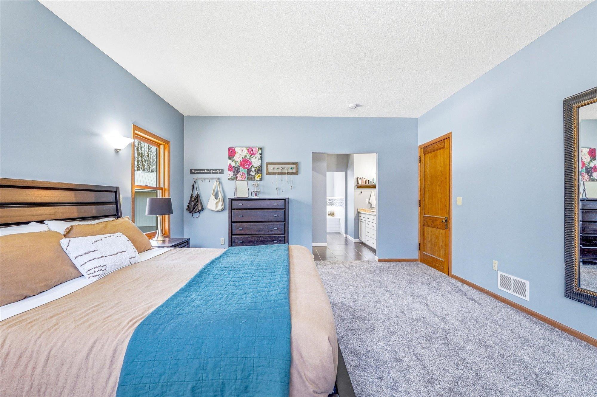 The primary suite is a true retreat, featuring a private bathroom, walk-in closet and laundry