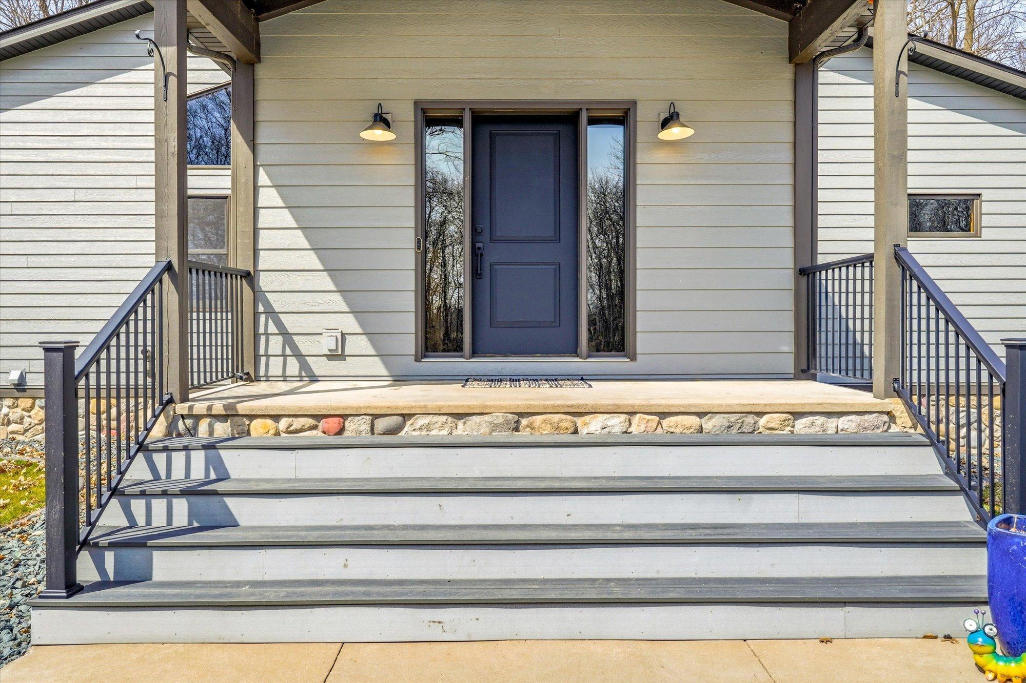 The composite front steps with aluminum custom railings were added in 2021.