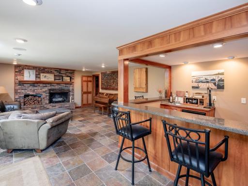 Enter the home on the Lower Level and enjoy the spacious family room, bar, recreation area and fireplace.