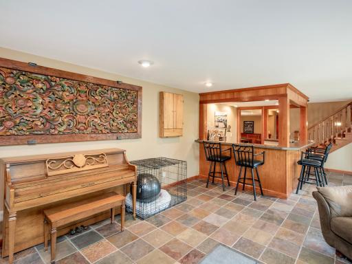 Enter the home on the Lower Level and enjoy the spacious family room, bar, recreation area and fireplace.