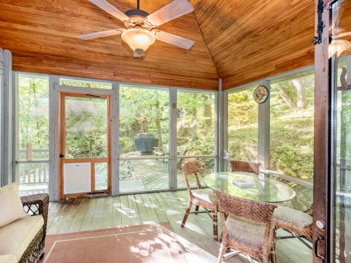 Screen porch off kitchen leads to the deck which wraps around the front of the home.